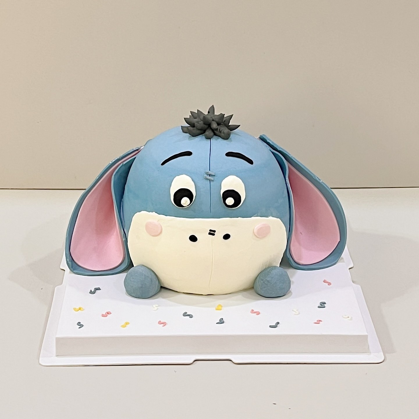 Blue donkey character cake with pink-lined floppy ears