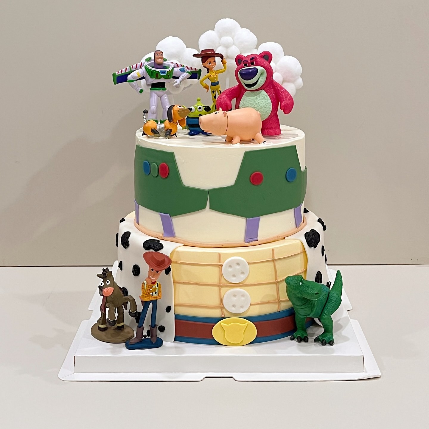 Two-tier space-ranger themed cake with character toy figurines
