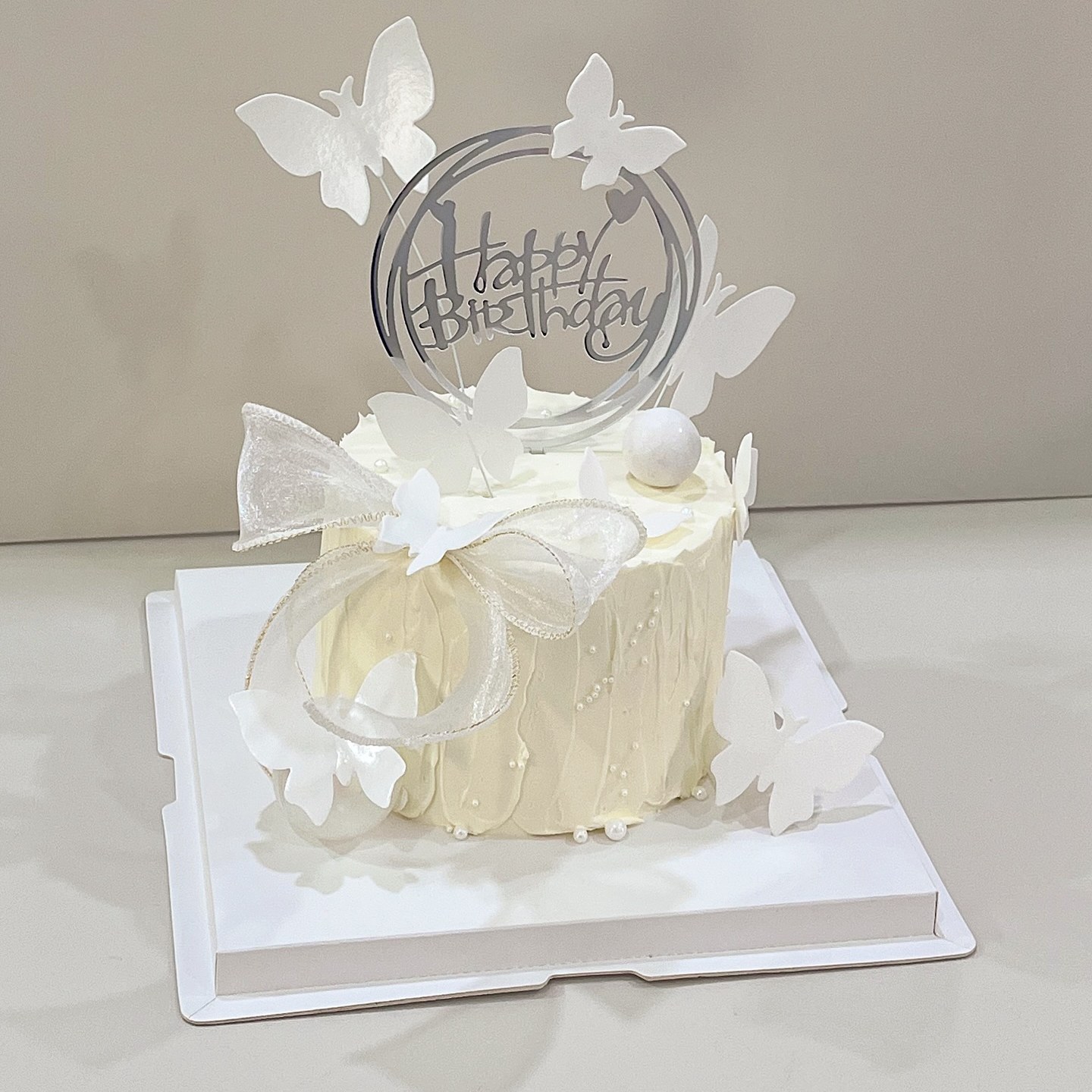 Minimalist flat-lay illustrated cake with a hand-drawn portrait